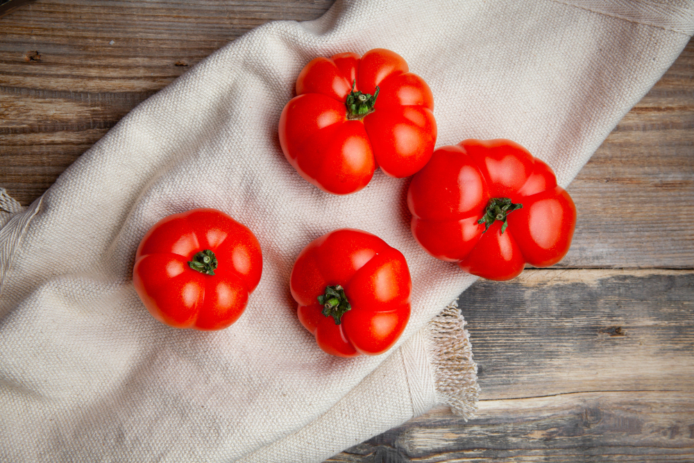 red brandywine tomatoes on a white cloth